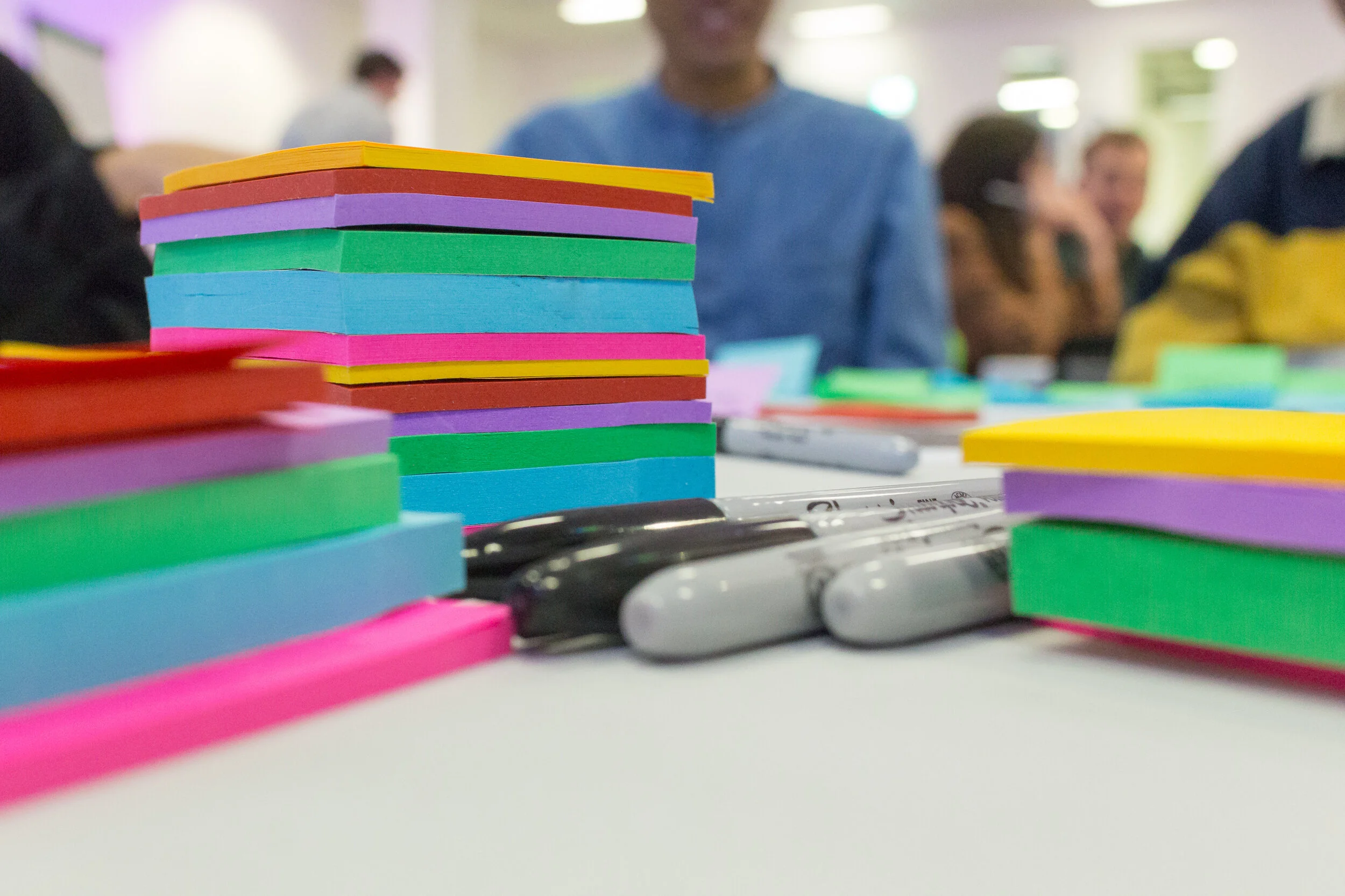 Stacks of sticky notes and markers
